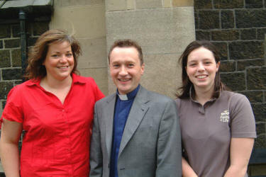 Lisa Megarry (left) and Jan Knowles (right) recently returned from missionary outreach work in Uganda, are pictured with the Rector, the Rev Paul Dundas at morning worship at Christ Church Parish on Sunday 10th September.