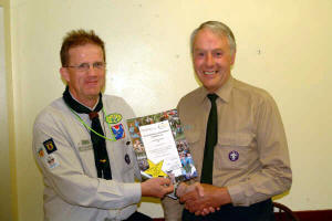 Noel Irwin - District Commissioner pictured presenting a Volunteering Achievement certificate to Lawrence Hook - 1st Anahilt Scout Group.