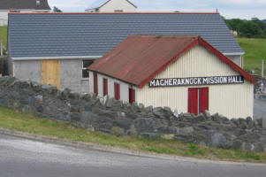 GOING: This picture taken in July shows the once familiar landmark of the old Magheraknock Mission Hall (in the foreground) and building work in progress on the new hall. 