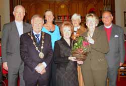 Carolyn Gowdy pictured presenting a basket of flowers and a copy of the recently launched recipe book �The Real Way to Cook� to special guests the Mayor - Councillor Trevor Lunn and the Mayoress - Mrs Laureen Lunn at the Festival of Nine Lessons and Carols at Railway Street Presbyterian Church on Sunday afternoon 24th December (Christmas Eve). Included are L to R: (back row) Rev Brian Gibson, Mrs Jean Gibson, Mrs Kathleen Cromie and the Very Rev Dr Howard Cromie.