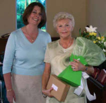 Lesley Highfield presents a bouquet of flowers to Ada Kirkwood (organist) in recognition of 50 years service to St Andrew's.