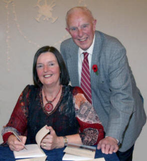 Jean signs a copy of her book for her father, Samuel Stewart from Coleraine.