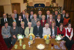 Second Dromara Presbyterian Church Choir pictured at the Harvest Thanksgiving Service on Monday 22nd October 2007.  L to R: (seated) Eileen Walsh, Glenis Heanen, Ann Mooney, Sadie Hanna, Rev David Porter, Mrs Gwen Doran (Organist and Choir Mistress), Ann Marshall, Nicola Kinghan and Lynne Johnston. (second row) Tilly Kerr, Noleen Holmes, Roberta McDowell, Rachel McDowell, Ida Annett, Evelyn Hanna, Margaret Easton and Pauline Johnston. (back row) David Doran, Stanley Poots, Dennis Easton, Ian Beattie, Billy Beattie, Hubert Steele, Bruce Steele and Brian Patterson