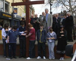 The Rev Canon Sam Wright, Rector of Lisburn Cathedral, gives the blessing during a short act of worship in Market Square on Good Friday. 