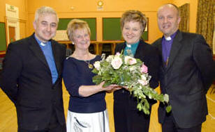 Irene Bell (St Colman�s MU Branch Leader) presents a welcoming gift to the new Rector of Dunmurry Parish, the Rev Denise Acheson. Looking on is the Rev Don Gamble (left) and the Bishop of Connor, the Rt Rev Alan Abernethy (right).