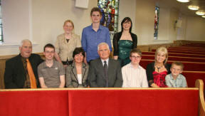 Tom Davidson and his wife Beryl pictured at a new pew which they donated in memory of their infant son Kyle Thomas Davidson who sadly died on 7th April 1987 at the age of just six months. Included are their sons Rowan and Jonathan and Tom�s brother Kenneth (left) and his sister Ann Cobb and family.