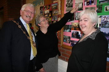 Maisie Reid and Dorothy Armstrong (right) point out a picture of a young Ronnie Crawford (now the Lisburn Mayor) at the first BCM camp at Carnlough in August 1966.