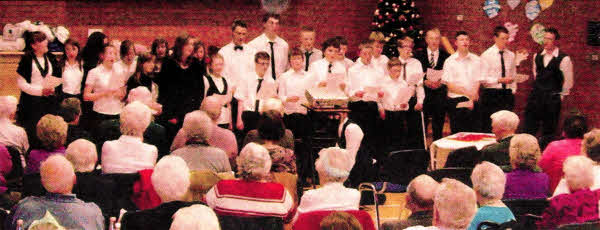 Enjoying the Carol singing at the Seniors' dinner in Lisburn Baptist Church.