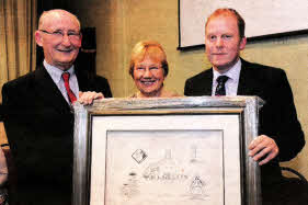 Andrew Clarke (People's Churchwarden) presents a framed print of the Middle Church to Canon Ernest Harris and his wife Ray.