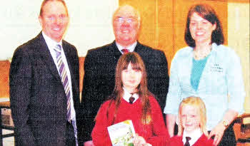 Pastor Clifford Morrison, Carr Baptist Church, with Mr. Trevor Carruthers, Principal of Riverdale Primary School and Rachel Brown, The Amazing Journey Co-ordinator presenting Bible's to some of the pupils.