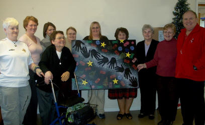 The Chinwags group display a unique piece of aboriginal art work which will be displayed at ATLAS in Sloan Street.