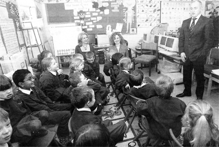 Barry McGuigan speaks with children at the opening of Rowandale Integrated Primary School on Tuesday. US0308-105A0