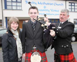 Ballycoan junior piper Jamie Walker pictured with his girlfriend Samantha Gordon and Samantha’s father, Banbridge man Alex Gordon (RSPBA NI Vice Chairman).