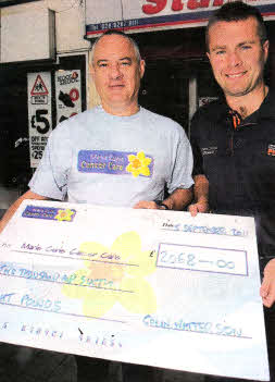Colin Watterson handing over a cheque for £2068 to Phil Kane community Fundraising Manager of Marie Curie Cancer Care. US3611-108A0