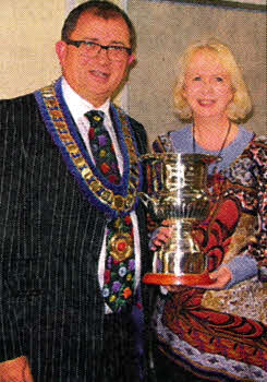 Sam Baird, performing one of his last duties as chairman of Dromore Beekeepers' Association in presenting the 'Senior Biology Cup' from Dromore Beekeepers' Association to Hazel Uprichard, the head of Science at Dromore High School. This is to recognize that Dromore High School has now a sixth form department and is preparing 26 students for A level Biology.