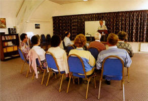 A small group meeting in one of the upstair lounges of the Cathedral Hall