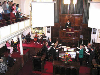 The Rev. John Brackenridge - Minister of First Lisburn, Tom Whyte - Organist and a group of musicians (including three of the minister’s family) pictured during morning service at this beautiful Lisburn City Centre Presbyterian Church.