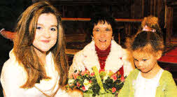 Olivia McAteer and Jenna Foyle, the oldest and youngest Sunday School children, pictured presenting a gift to Mrs Kathy Devenney on behalf of the Sunday School.