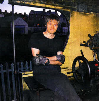 Adam Lohoff sitting on the drivers seat of one of the steam locomotives.