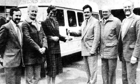 Miss Geraldine Tigchelaar, Headmistress of Fort Hill Girls' School, Lisburn, receives the keys of a new minibus from Mr John Millar from Dick and Comany, Mallusk.