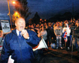 Protester's make their voice heard outside the site of the old Maze prison as Jim Allister speaks to the large crowd gathered. Picture Mark Marlow/Pacemaker press.